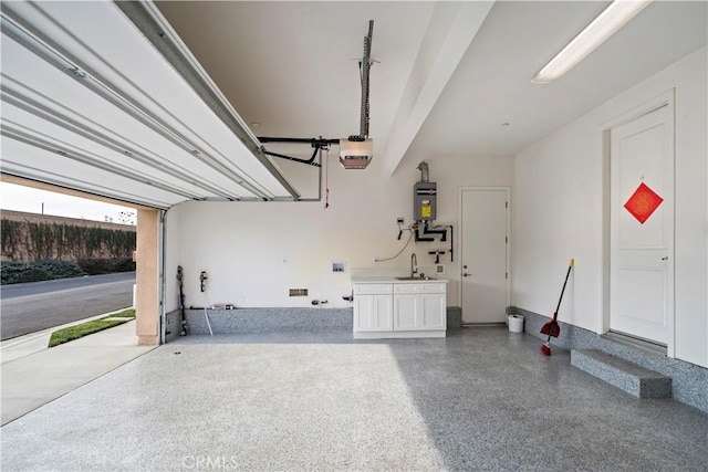 garage featuring a garage door opener, water heater, and sink