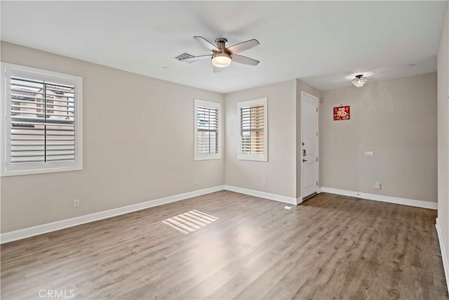 unfurnished room with ceiling fan and wood-type flooring