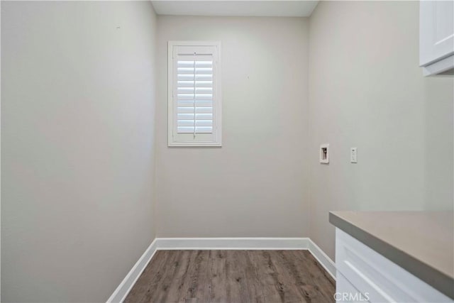 washroom featuring washer hookup, cabinets, and hardwood / wood-style flooring