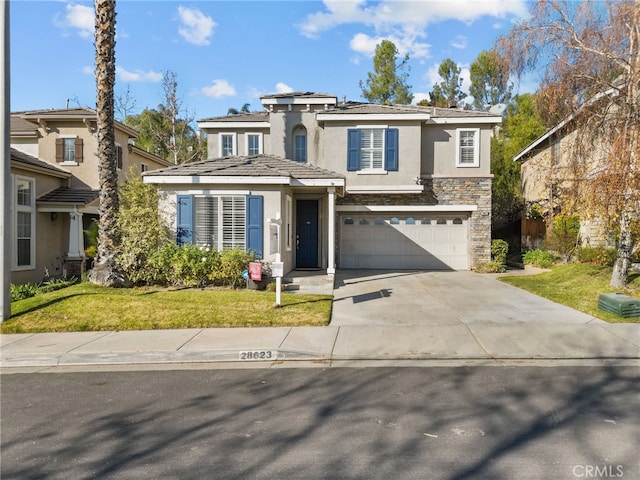 view of front of house featuring stucco siding, concrete driveway, an attached garage, a front yard, and stone siding