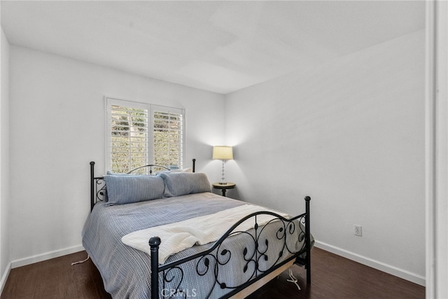 bedroom with dark hardwood / wood-style flooring