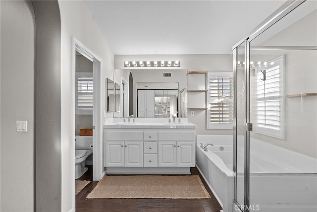 full bathroom with plenty of natural light, wood-type flooring, and vanity