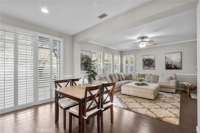 dining space featuring ceiling fan, dark hardwood / wood-style floors, and crown molding