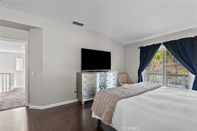 bedroom with vaulted ceiling, dark wood-type flooring, and access to exterior