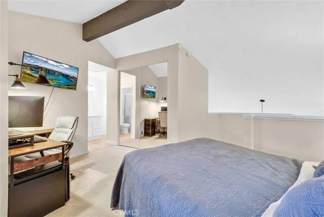 bedroom featuring ensuite bathroom, light colored carpet, and vaulted ceiling with beams