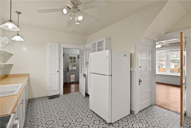 kitchen featuring a sink, a healthy amount of sunlight, ceiling fan, and freestanding refrigerator