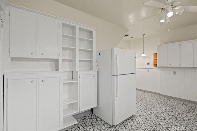 kitchen with pendant lighting, open shelves, white cabinetry, freestanding refrigerator, and ceiling fan