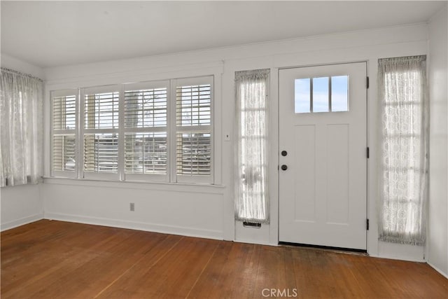 entryway featuring baseboards and hardwood / wood-style flooring