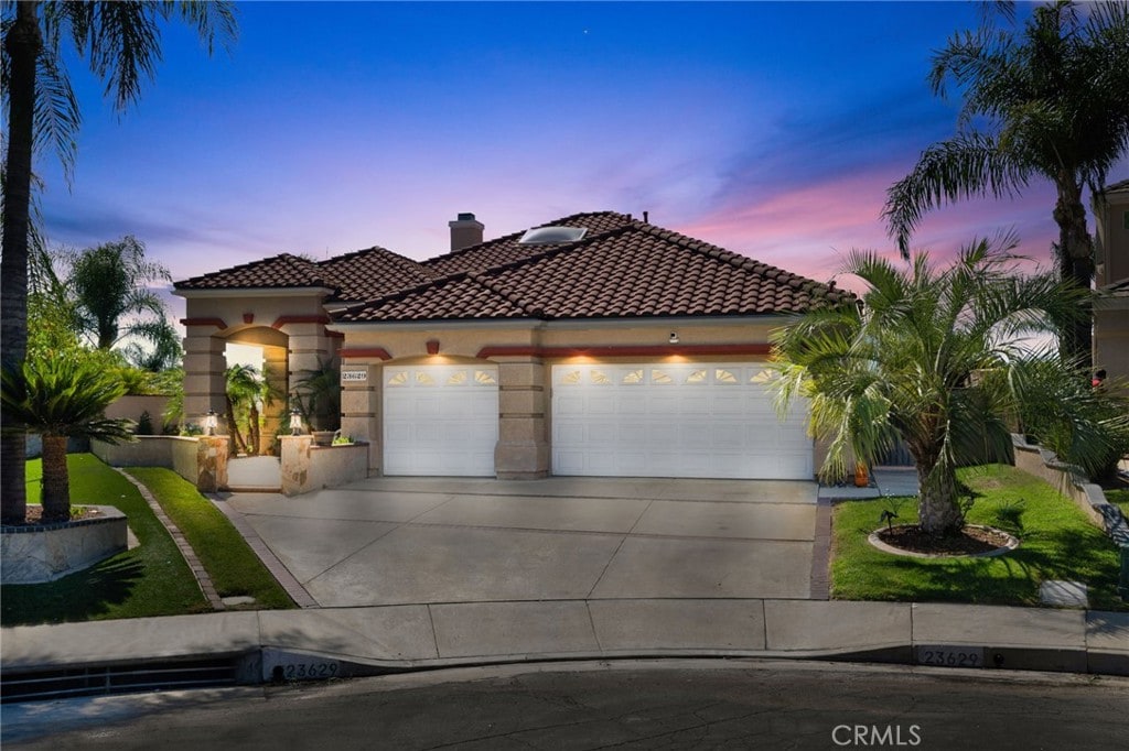 mediterranean / spanish house with a garage