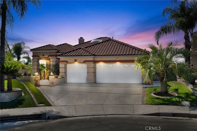 mediterranean / spanish house with a garage