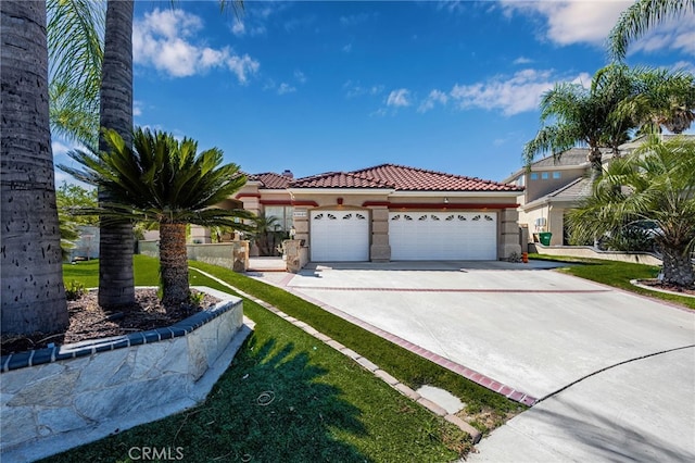 mediterranean / spanish-style home with a garage