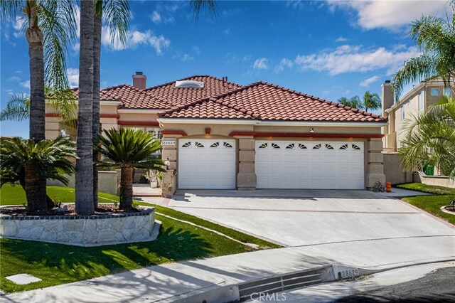 mediterranean / spanish house featuring a garage