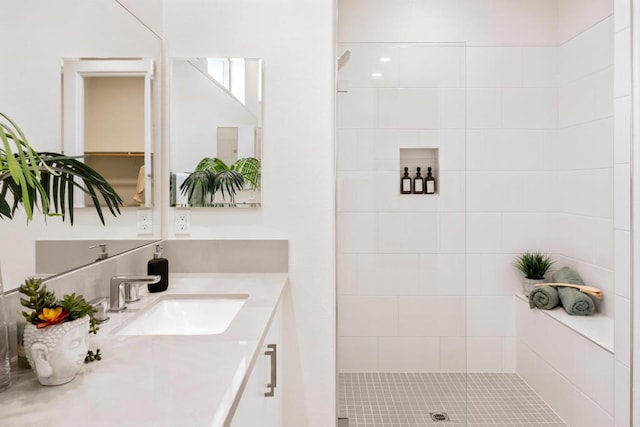 bathroom with vanity and tiled shower