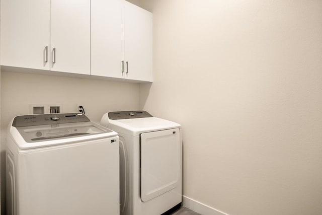 laundry room with cabinets and washer and dryer