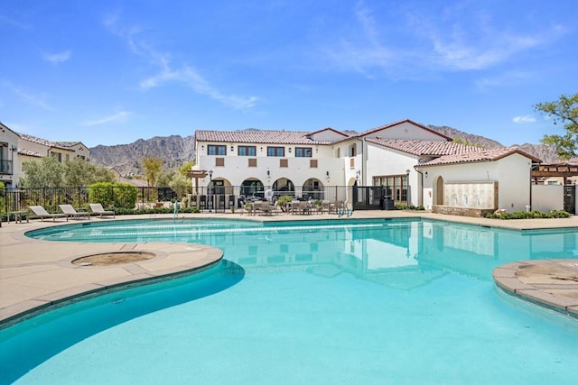 view of swimming pool with a mountain view