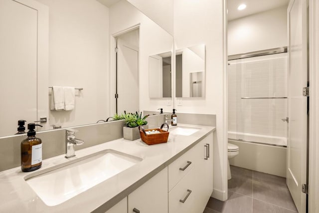 full bathroom featuring toilet, tile patterned floors, enclosed tub / shower combo, and vanity