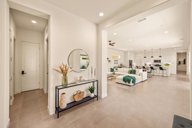 hall featuring light tile patterned floors