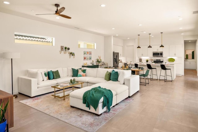 tiled living room featuring ceiling fan