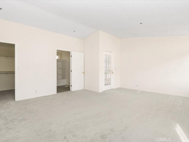 empty room with carpet and a textured ceiling