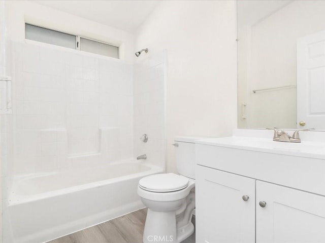 full bathroom with tub / shower combination, vanity, wood-type flooring, and toilet