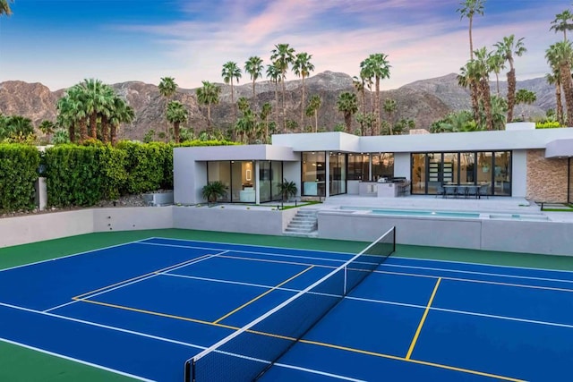 view of tennis court with a mountain view