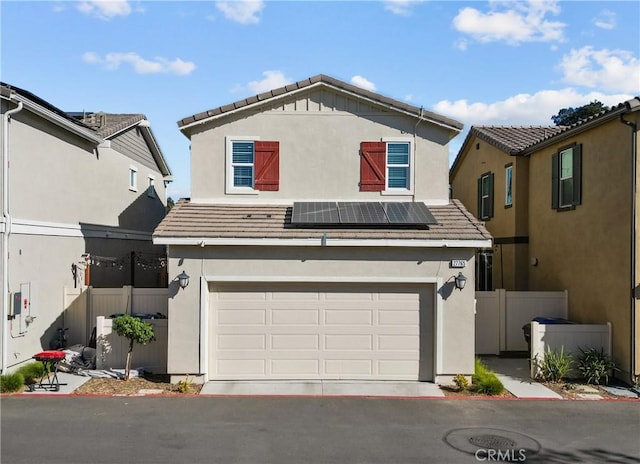 front of property featuring solar panels and a garage