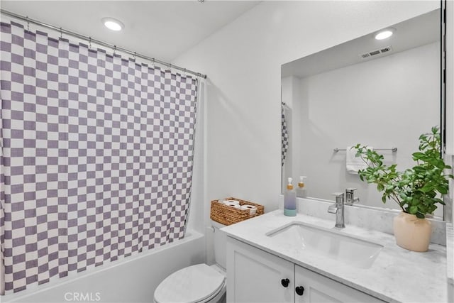 full bathroom featuring toilet, vanity, and shower / tub combo with curtain