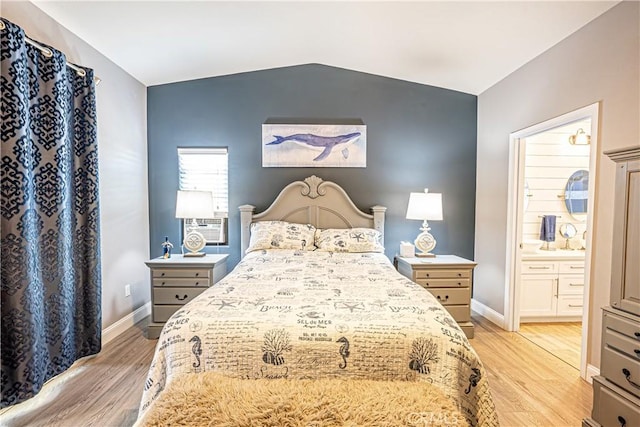 bedroom with vaulted ceiling and light hardwood / wood-style flooring