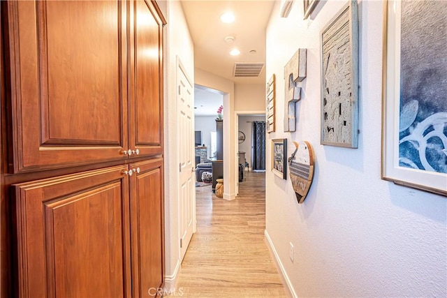 corridor featuring light hardwood / wood-style flooring