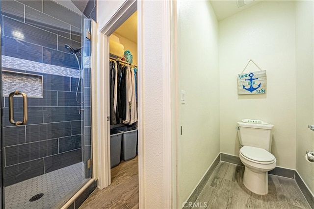 bathroom featuring toilet and walk in shower