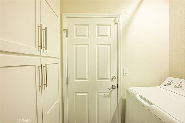 laundry area featuring washer / dryer and cabinets