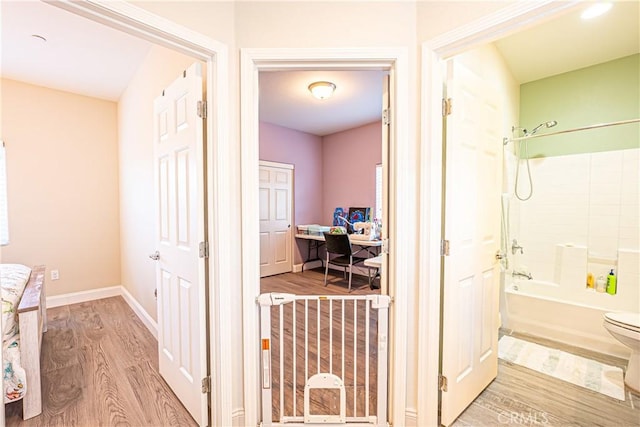 corridor with hardwood / wood-style flooring