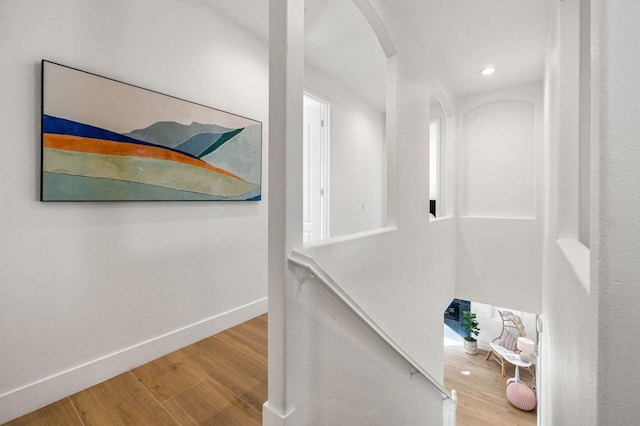 staircase with hardwood / wood-style flooring