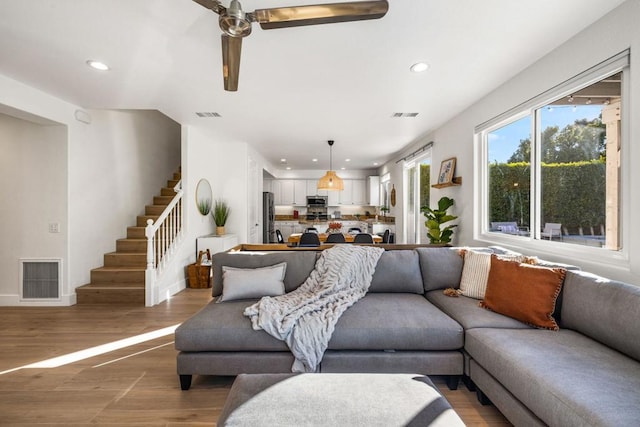 living room with hardwood / wood-style floors and ceiling fan