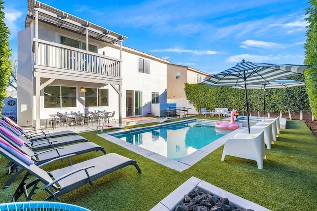 view of pool featuring a yard and a patio