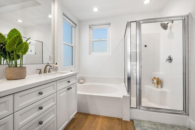 bathroom featuring vanity, wood-type flooring, and independent shower and bath