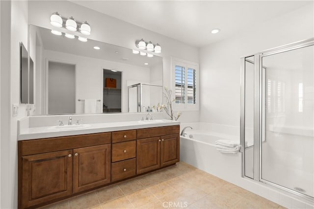 bathroom featuring independent shower and bath, tile patterned floors, and vanity