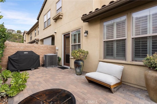 view of patio with cooling unit and area for grilling