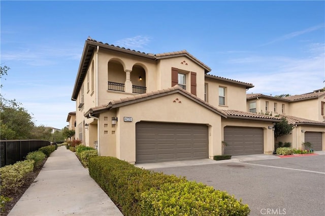 mediterranean / spanish-style home with a garage