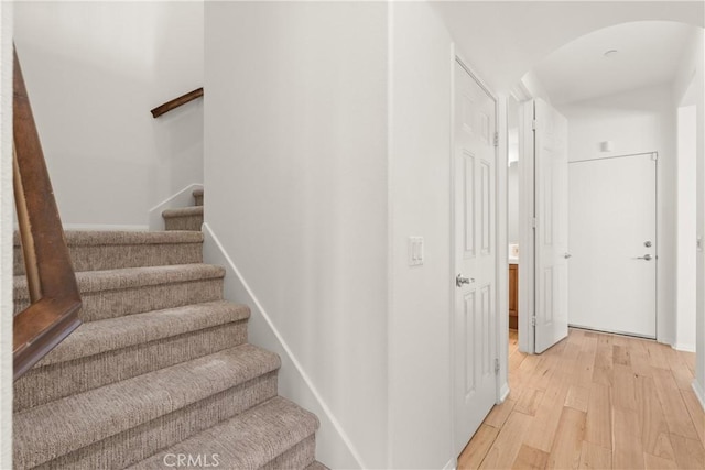 stairs with hardwood / wood-style flooring