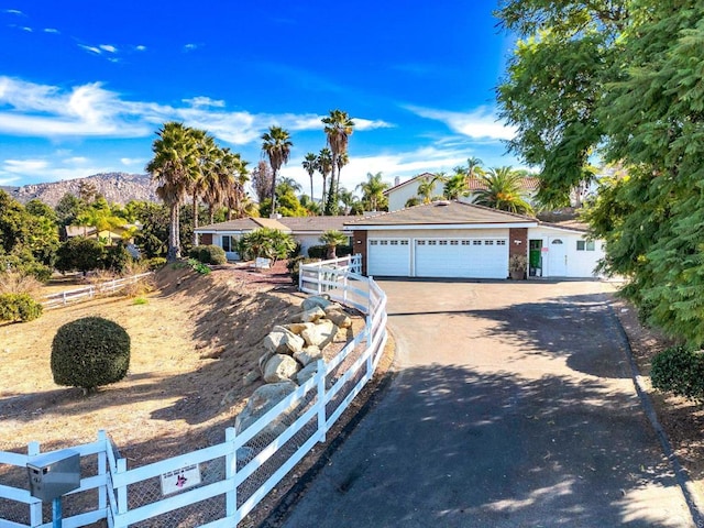 single story home with a mountain view and a garage