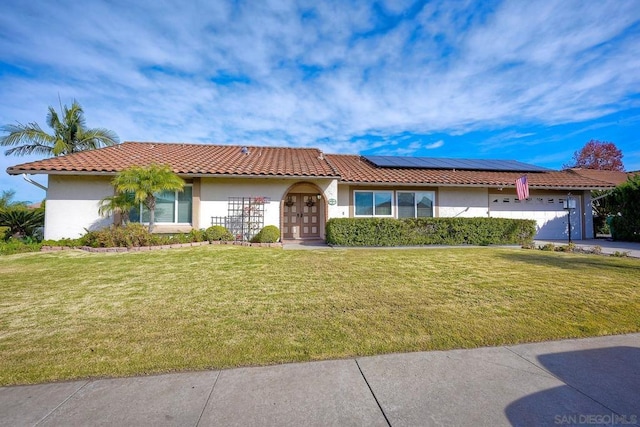 view of front of home with solar panels, french doors, and a front yard