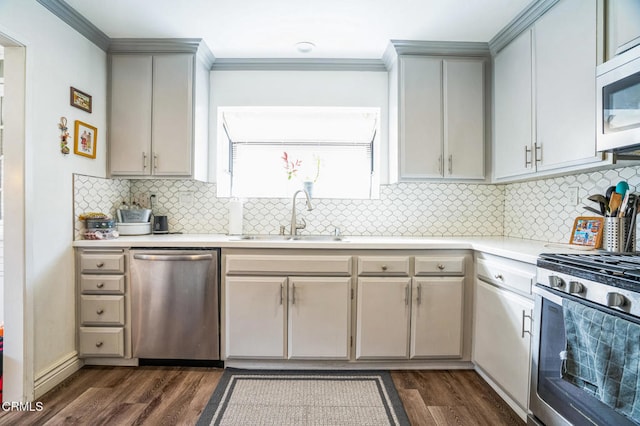 kitchen with tasteful backsplash, dark wood-type flooring, sink, and stainless steel appliances