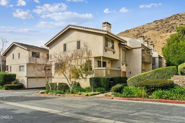 view of property with a garage and a mountain view