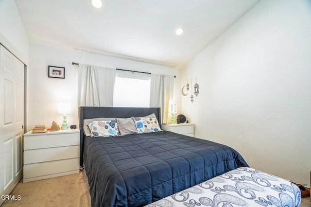 carpeted bedroom featuring lofted ceiling and a closet