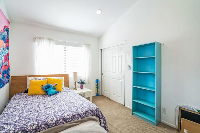 bedroom featuring a closet, carpet, and lofted ceiling