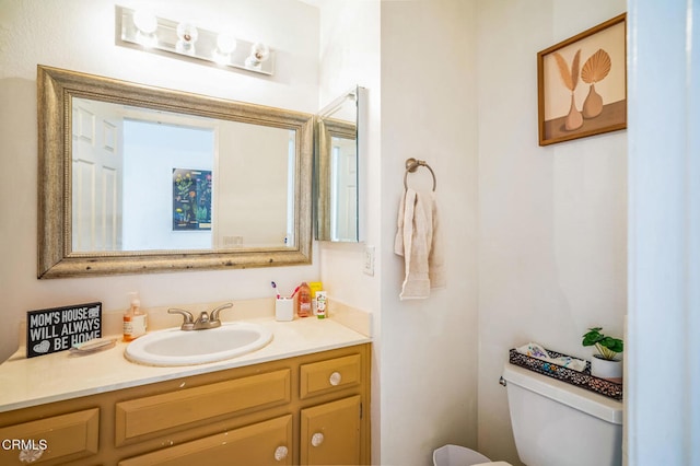 bathroom featuring toilet and vanity