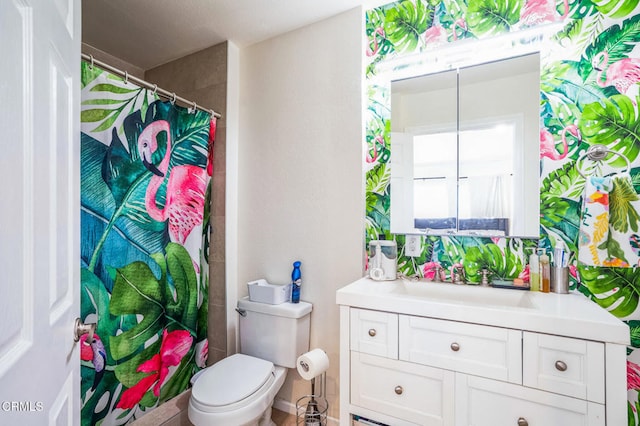 bathroom with toilet, vanity, and a shower with shower curtain