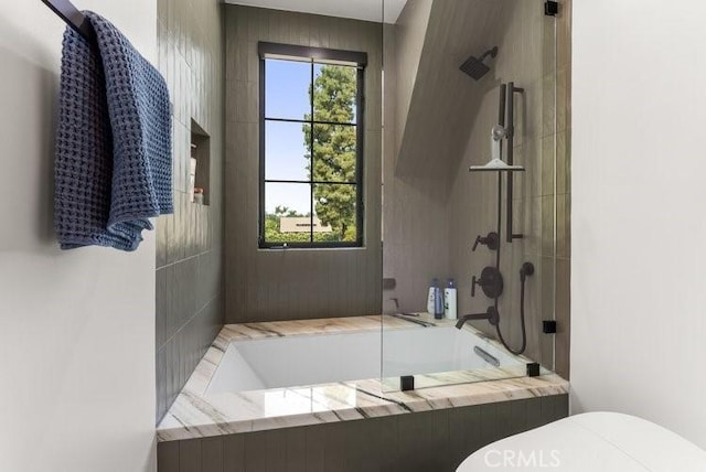 bathroom with toilet, a healthy amount of sunlight, and shower with separate bathtub