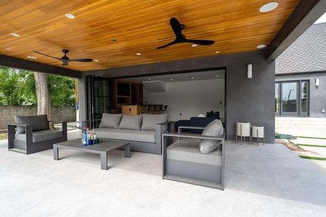 view of patio / terrace with ceiling fan and an outdoor living space